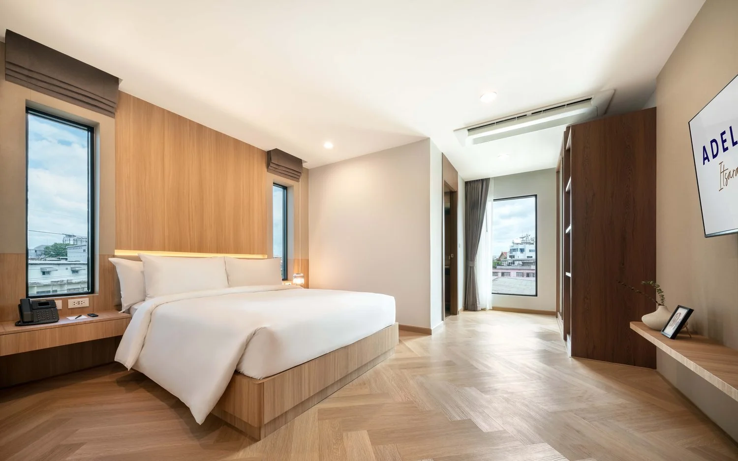 Deluxe Room 24 sqm with queen bed and warm wood accents